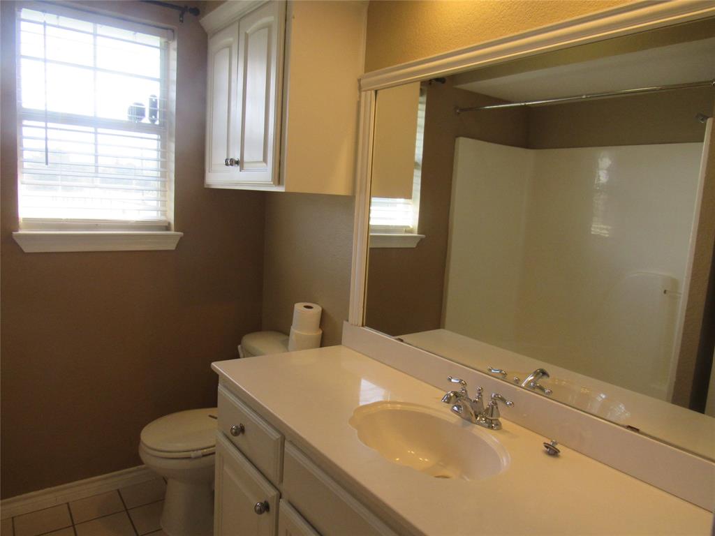 4019 East Fm 120 Denison, TX 75021 - Photo 30 of 39 a bathroom with a sink toilet and window