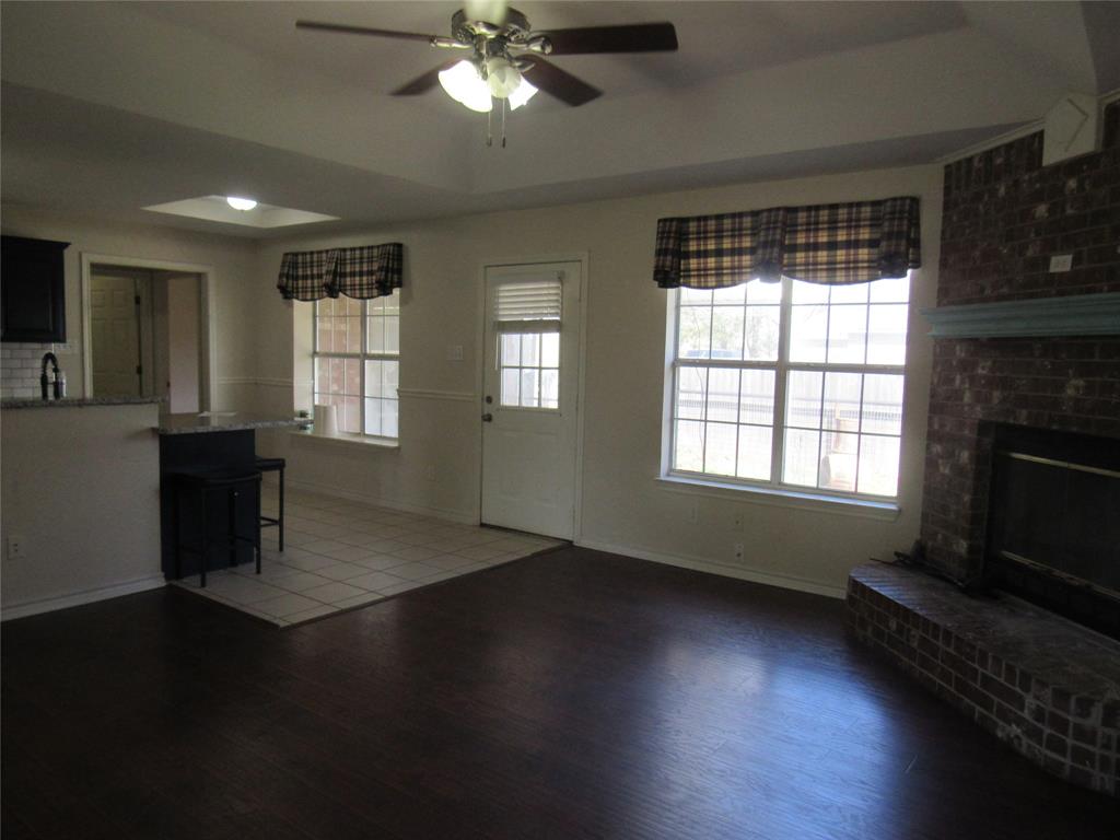 4019 East Fm 120 Denison, TX 75021 - Photo 10 of 39 a living room with hard wood floors and a fireplace