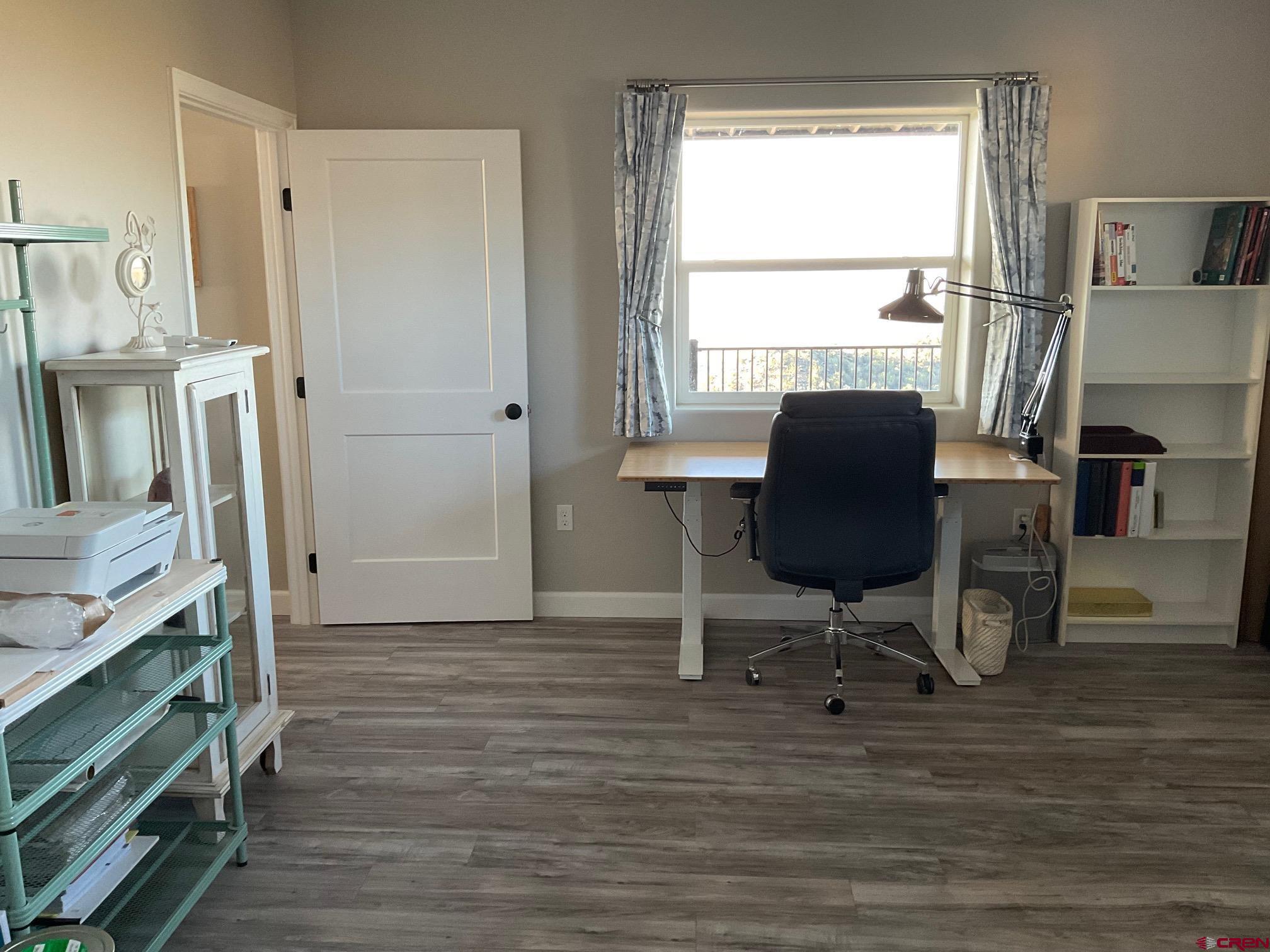 24203 Valley View Circle Cedaredge, CO 81413 - Photo 15 of 41 a view of a workspace with furniture and a window