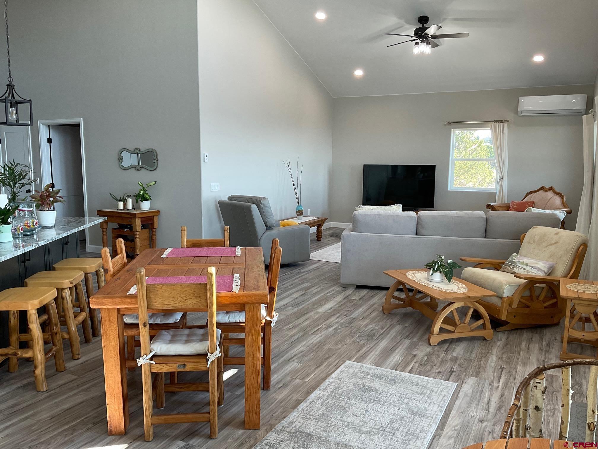 24203 Valley View Circle Cedaredge, CO 81413 - Photo 10 of 41 a living room with furniture a flat screen tv and kitchen view
