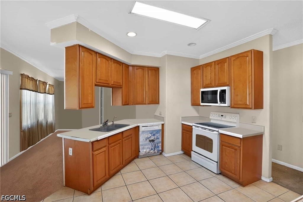 2808 34th Street Southwest Lehigh Acres, FL 33976 - Photo 5 of 14 a kitchen with stainless steel appliances granite countertop a sink stove and refrigerator