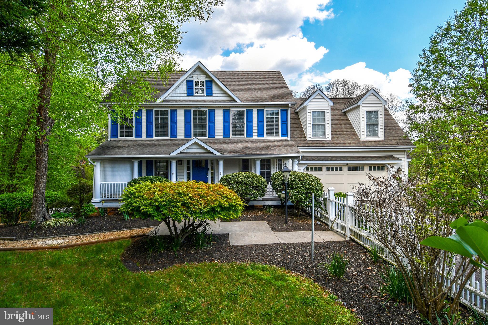 a front view of a house with garden and porch