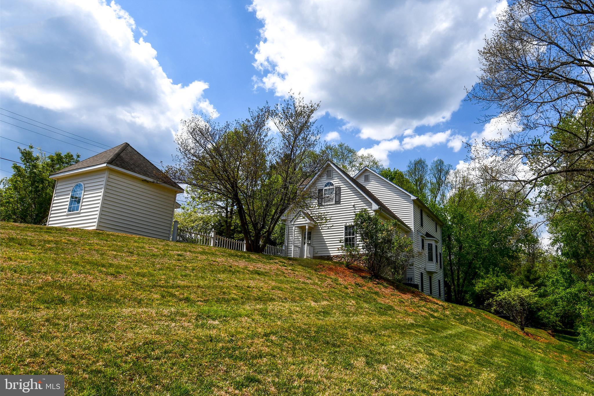 486 Tiger Valley Road Washington, VA 22747 - Photo 13 of 70 a yellow house with trees in front of it