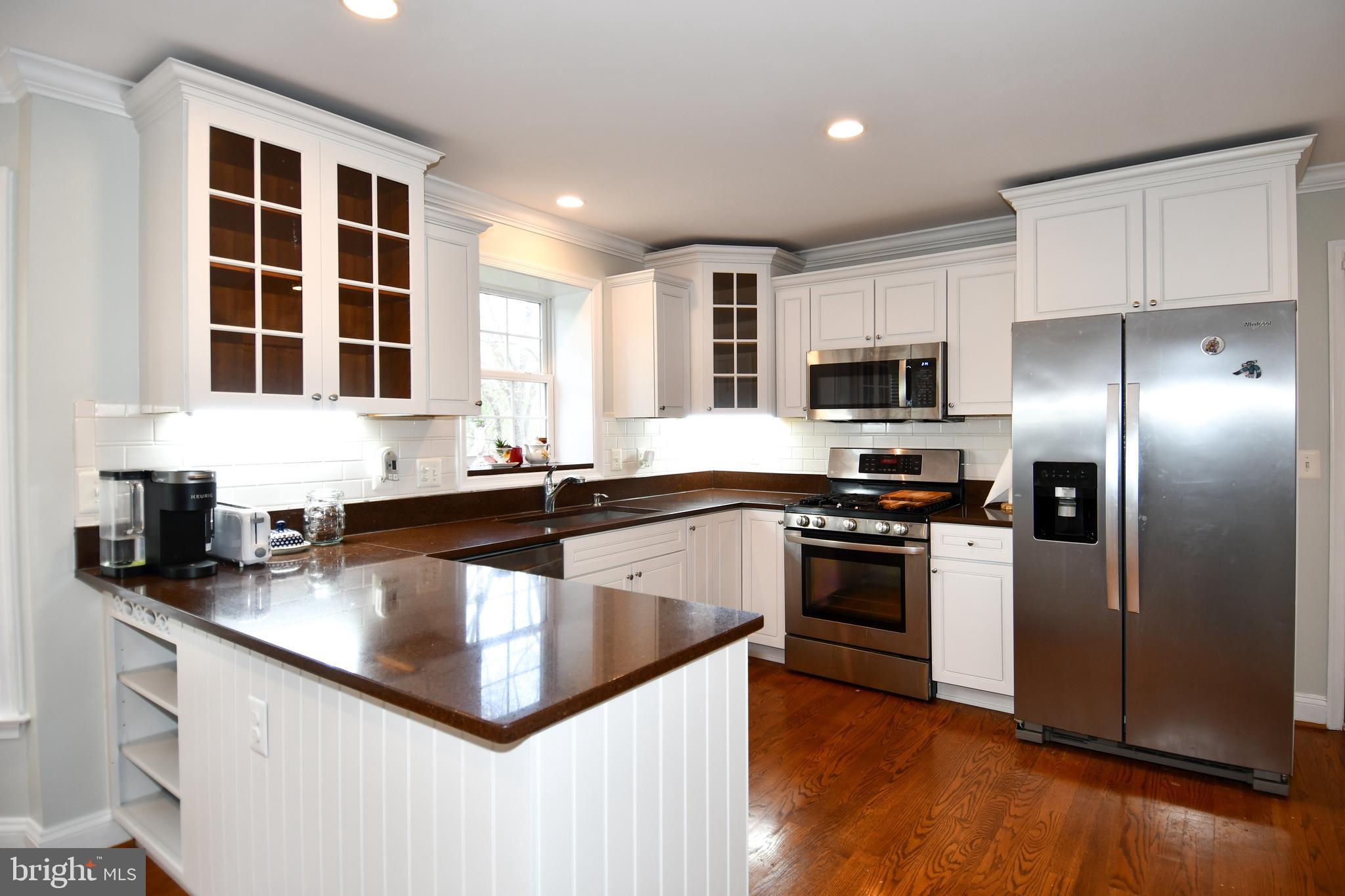 486 Tiger Valley Road Washington, VA 22747 - Photo 22 of 70 a kitchen with kitchen island granite countertop a sink cabinets and stainless steel appliances
