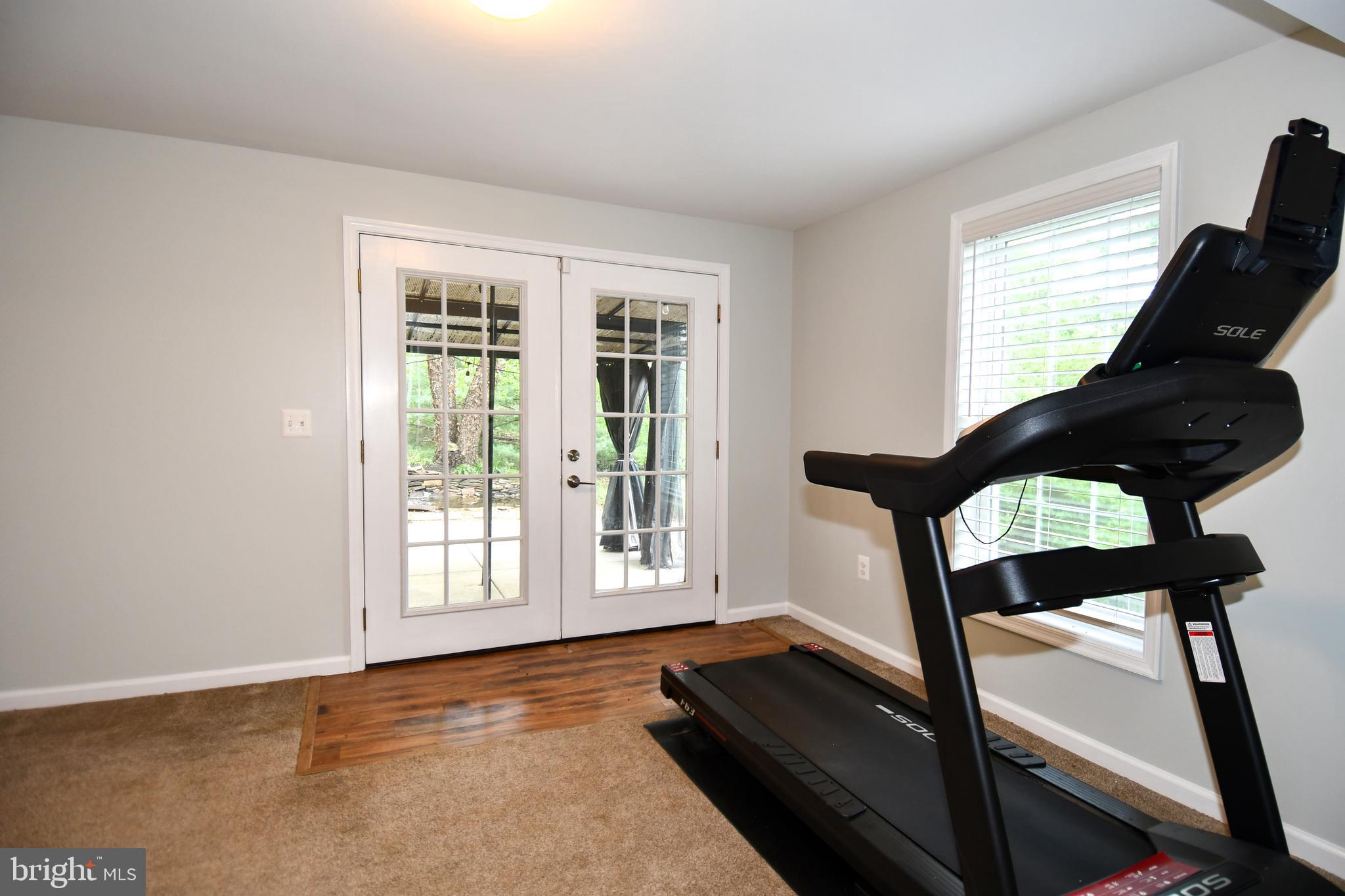 486 Tiger Valley Road Washington, VA 22747 - Photo 34 of 70 a view of an empty room with wooden floor and furniture