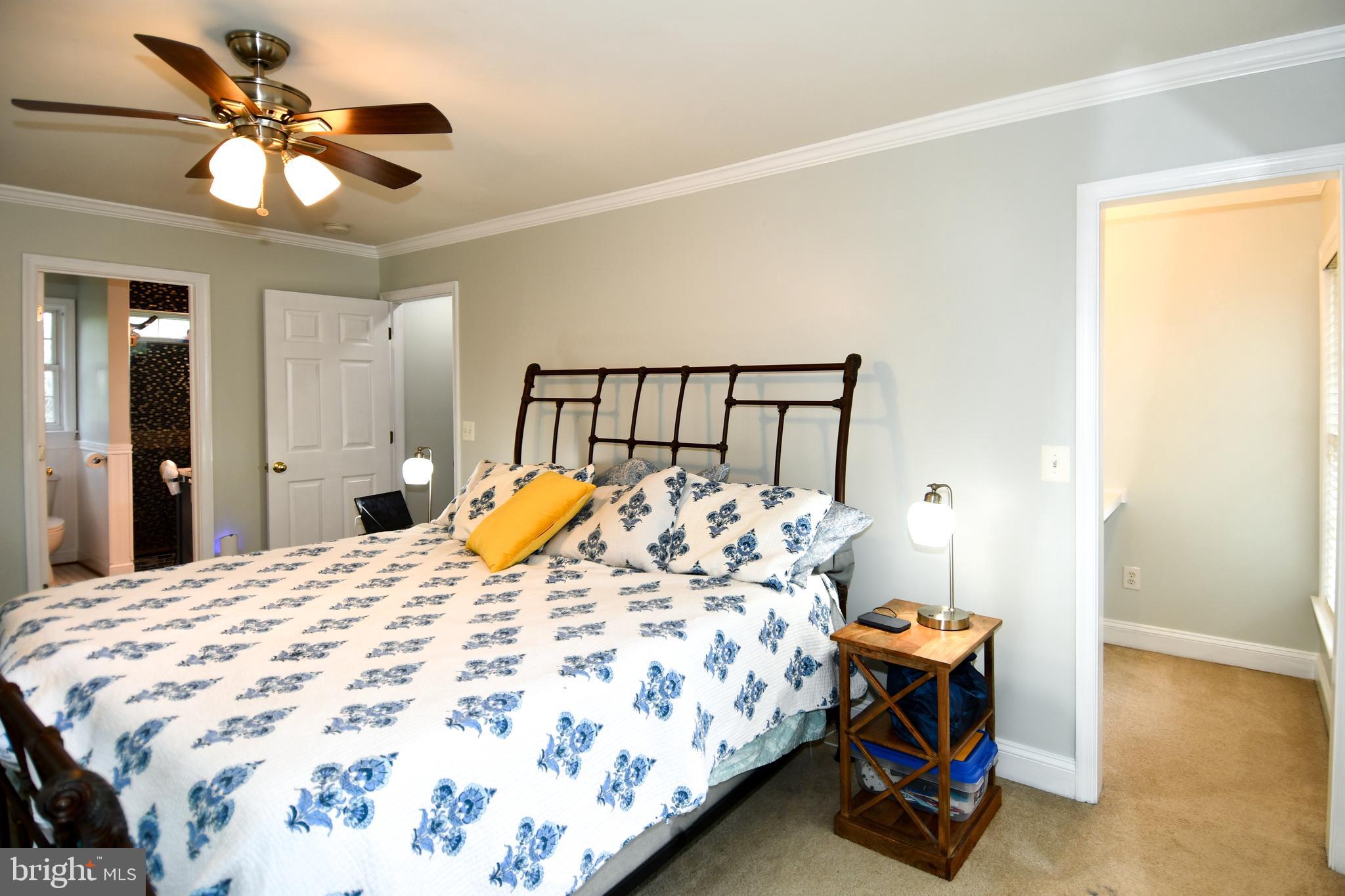 486 Tiger Valley Road Washington, VA 22747 - Photo 44 of 70 a bed sitting in a bedroom and a chandelier