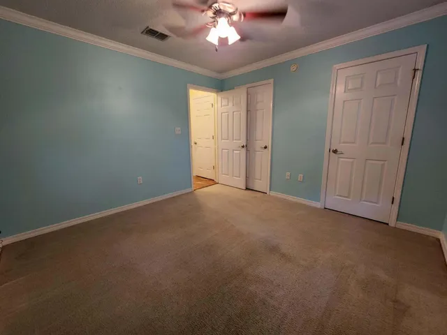 a view of a livingroom with a chandelier fan