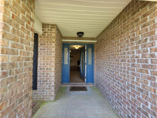 a view of a hallway with brick walls