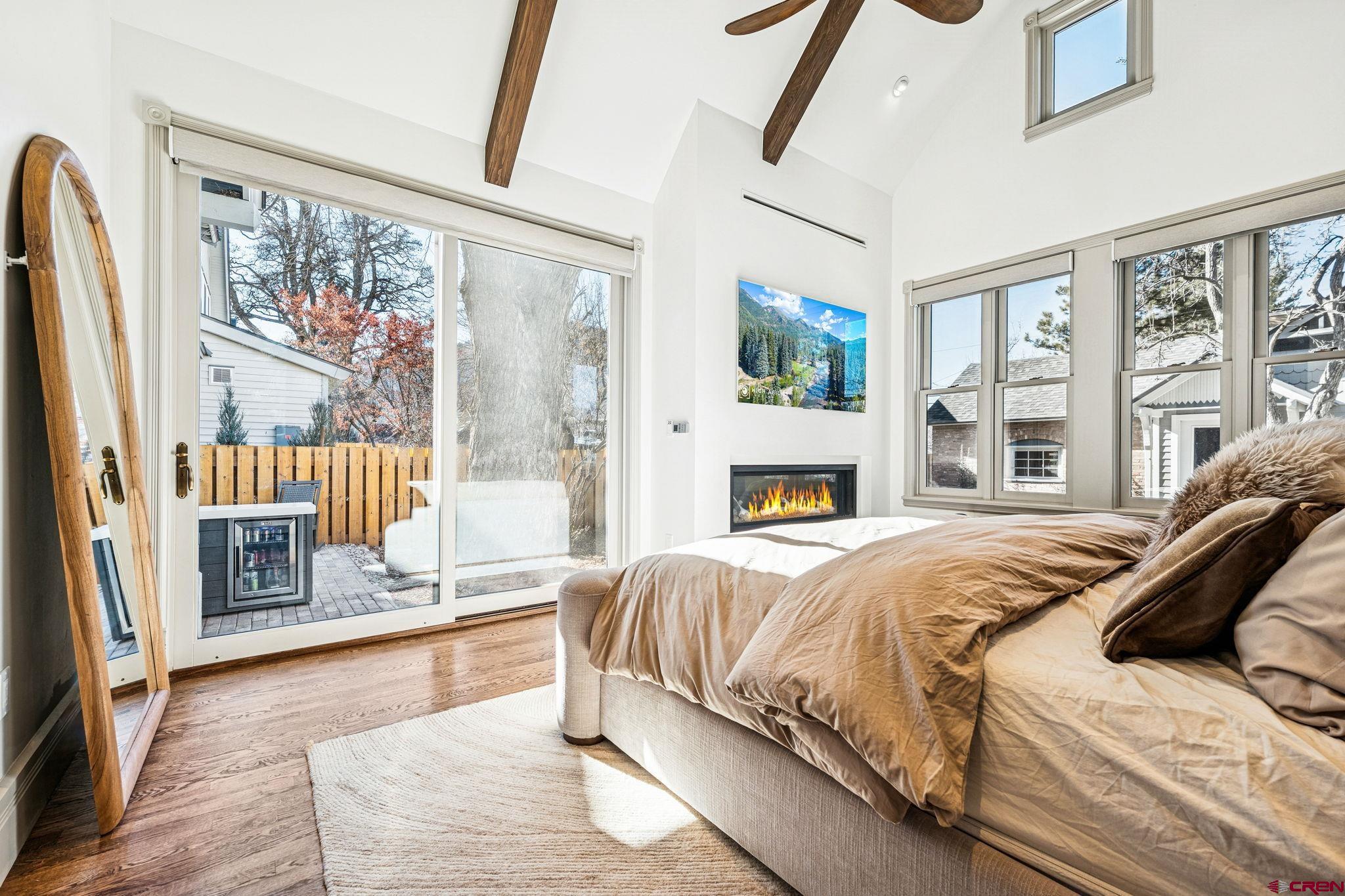 773 East 3rd Avenue Durango, CO 81301 - Photo 32 of 45 a spacious bedroom with a large bed and a fireplace
