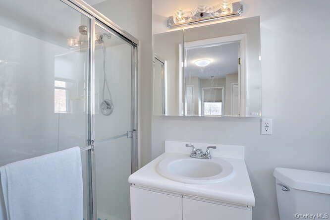 89 Spook Rock Road Suffern, NY 10901 - Photo 26 of 44 a bathroom with a sink a toilet and shower