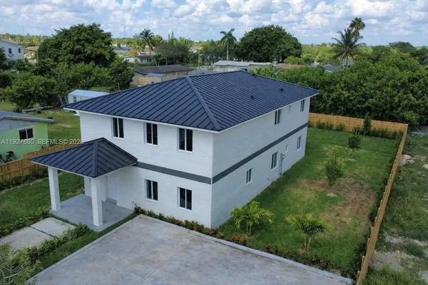 a aerial view of a house with a yard