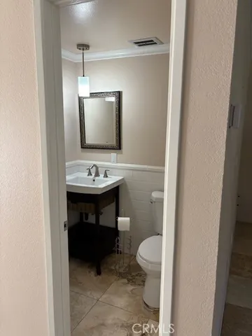 a bathroom with a toilet a sink and a mirror