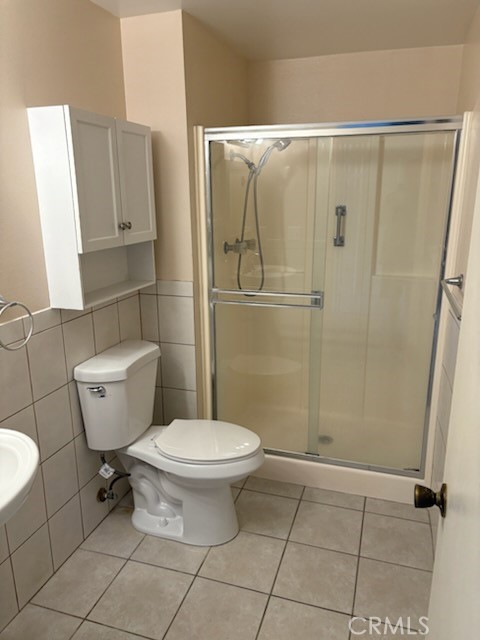 18243 Crater Lake Court Fountain Valley, CA 92708 - Photo 10 of 13 a bathroom with a toilet and a shower