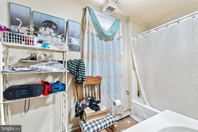 a bathroom with a sink vanity mirror and toilet