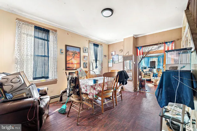 a dining room with wooden floor a glass table and chairs