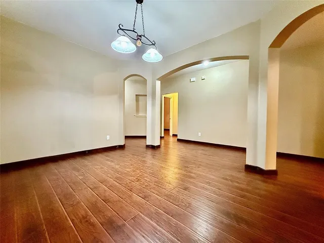 a view of a livingroom with wooden floor and a ceiling fan