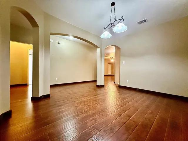 a view of a room with wooden floor window and a kitchen