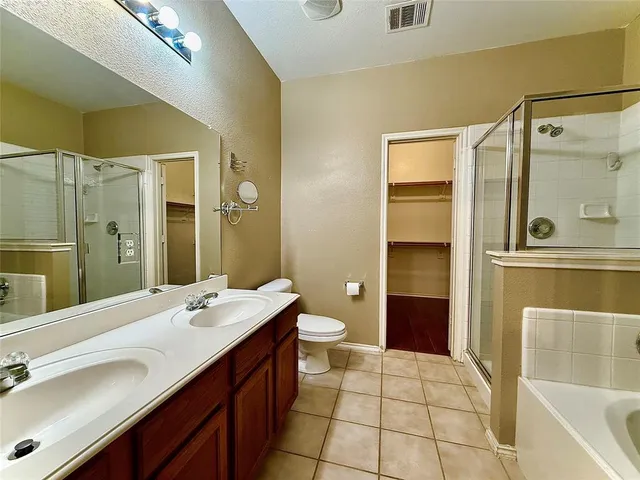 a bathroom with a double vanity sink toilet and shower