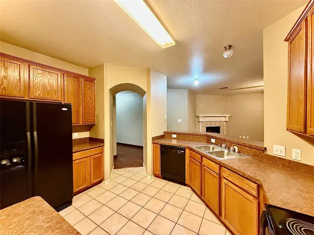 a kitchen with stainless steel appliances granite countertop a refrigerator stove and sink