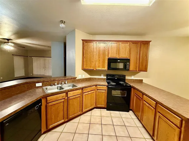 a kitchen with a sink stove and microwave