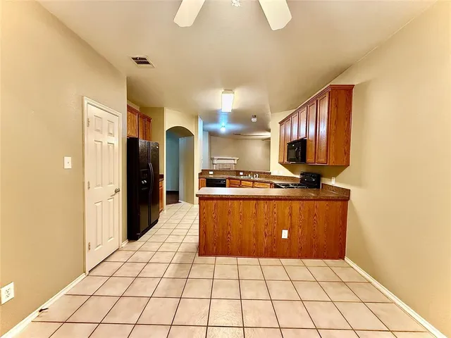 a kitchen with stainless steel appliances a refrigerator sink and cabinets