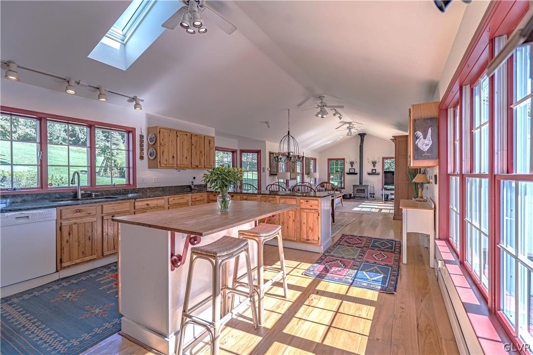 2884 Gallows Hill Road Riegelsville, PA 18077 - Photo 13 of 50 a kitchen with stainless steel appliances granite countertop a stove a sink dishwasher and cabinets with wooden floor