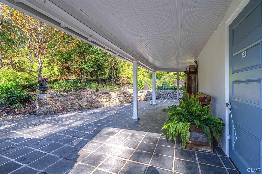 2884 Gallows Hill Road Riegelsville, PA 18077 - Photo 3 of 50 a view of a porch with chairs and potted plants