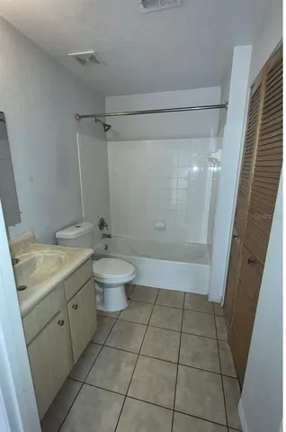 a bathroom with a granite countertop sink a toilet and a shower