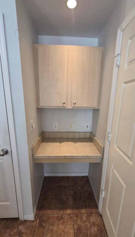 1990 Erving Circle, Unit 102 Ocoee, FL 34761 - Photo 15 of 28 a room with wooden floor and white wall