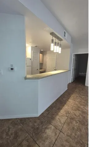 a view of a kitchen cabinets and chandelier