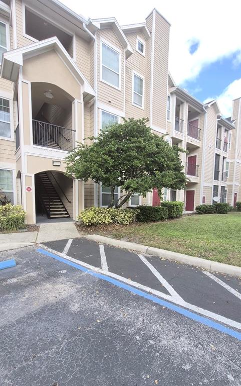 1990 Erving Circle, Unit 102 Ocoee, FL 34761 - Photo 2 of 28 a front view of a building with a garden and plants