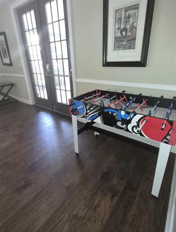 1990 Erving Circle, Unit 102 Ocoee, FL 34761 - Photo 22 of 28 a living room with furniture and a wooden floor