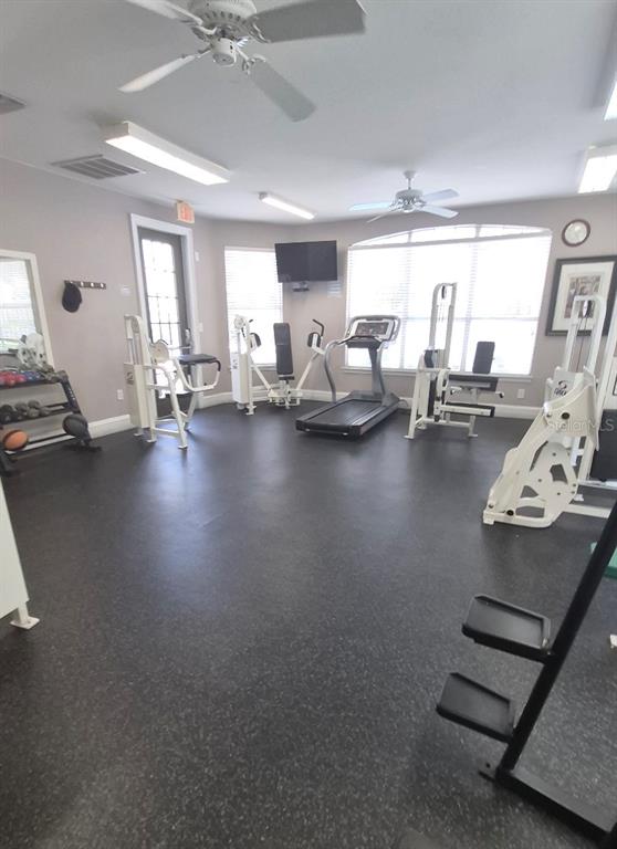 1990 Erving Circle, Unit 102 Ocoee, FL 34761 - Photo 23 of 28 a gym room with furniture and a chandelier