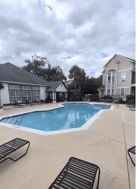 1990 Erving Circle, Unit 102 Ocoee, FL 34761 - Photo 25 of 28 a view of a house with a swimming pool