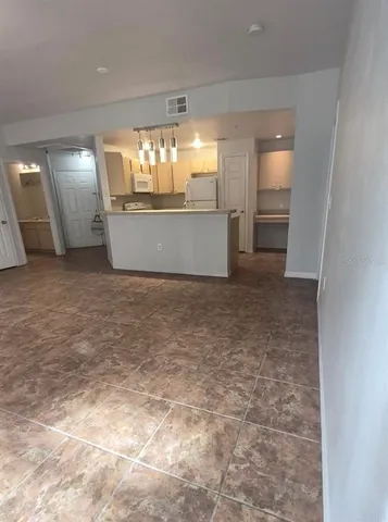 an empty room with windows and entrance