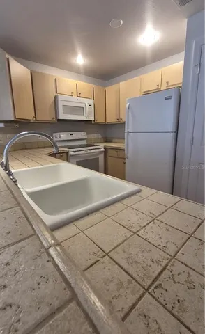 a kitchen with a sink cabinets and appliances