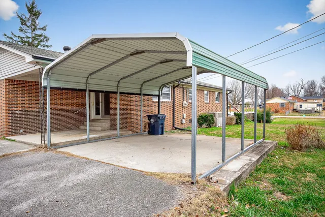 a view of a house with a yard and porch