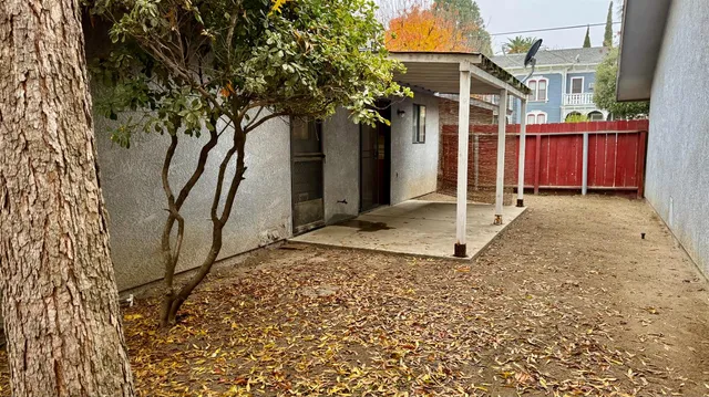 a view of a house with a tree in a yard