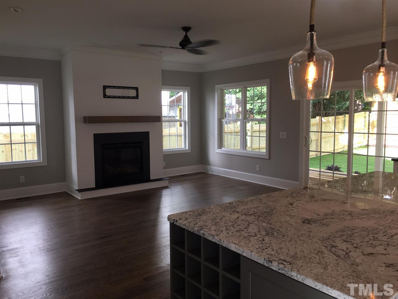 1706 Scales Street Raleigh, NC 27608 - Photo 2 of 3 a view of an empty room with wooden floor and a window