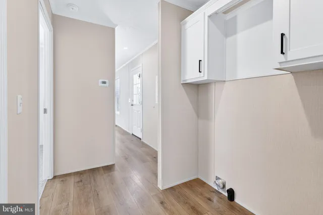 a view of hallway with wooden floor