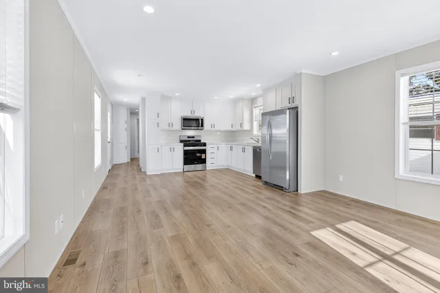a view of a kitchen with a sink and a refrigerator