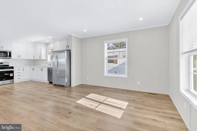 a view of kitchen with refrigerator and window
