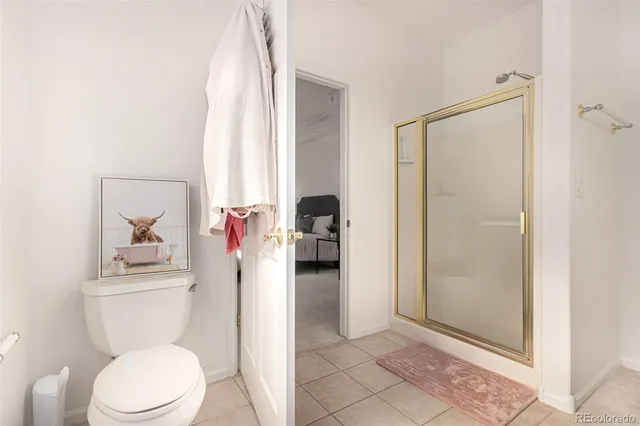 a bathroom with a toilet and a shower