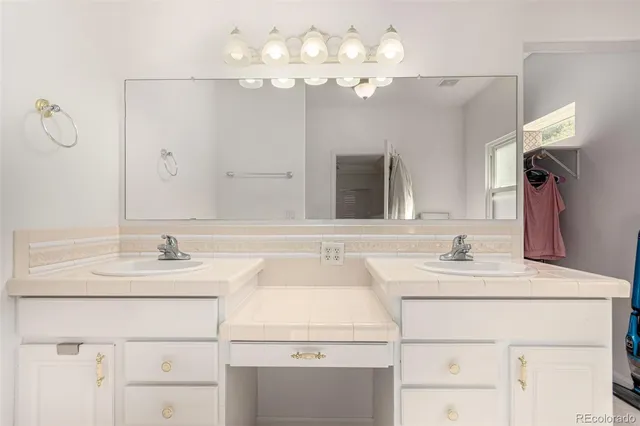 a bathroom with a sink vanity and a mirror