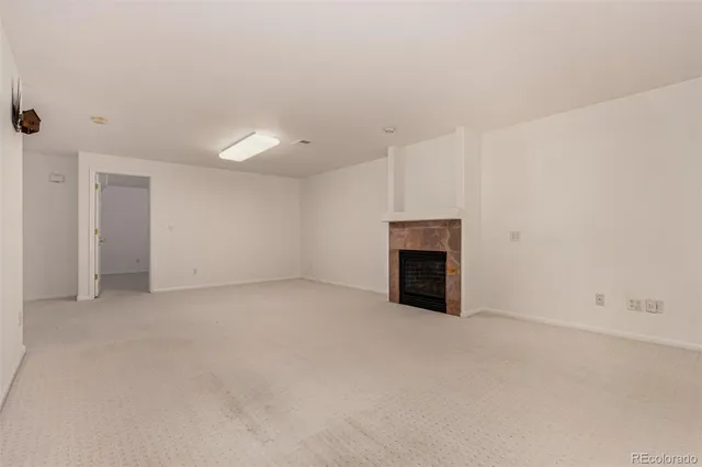 a view of an empty room with a fireplace