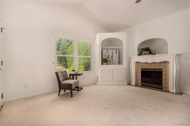 a living room with furniture and a fireplace