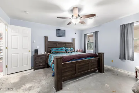 a bedroom with a bed and a window