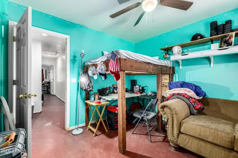 a view of living room filled with furniture and a window
