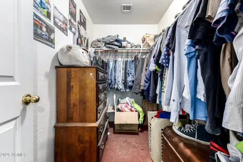 a utility room with furniture and a fan