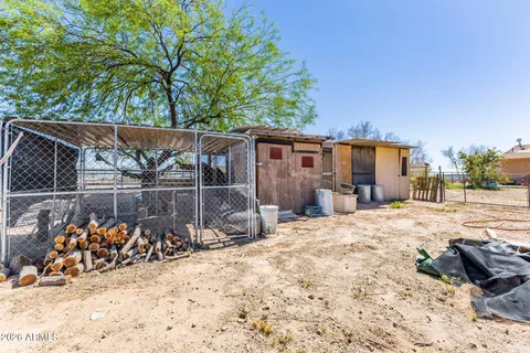 a view of a backyard of a house with wooden fence